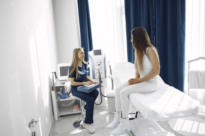 Canva - Woman in Blue Scrub Suit Helping Woman Sitting on Bed (1)