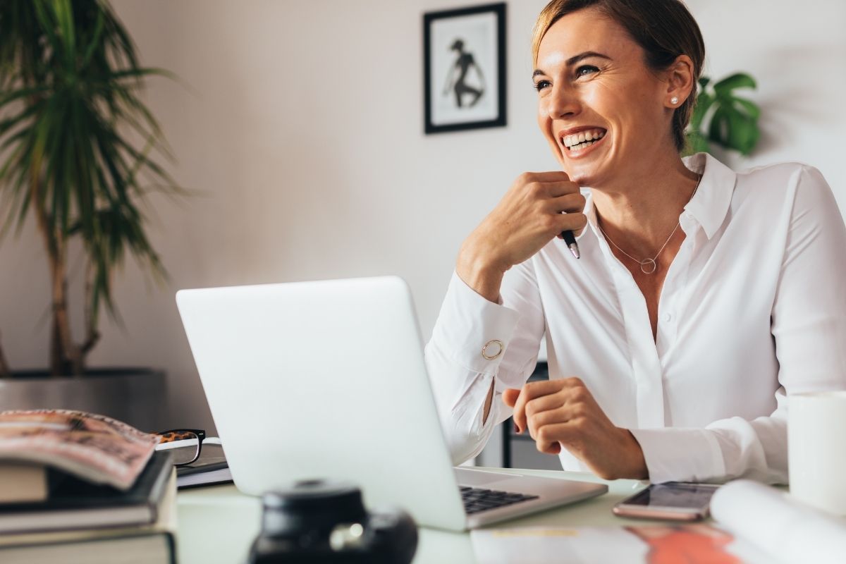 woman laughing by computer