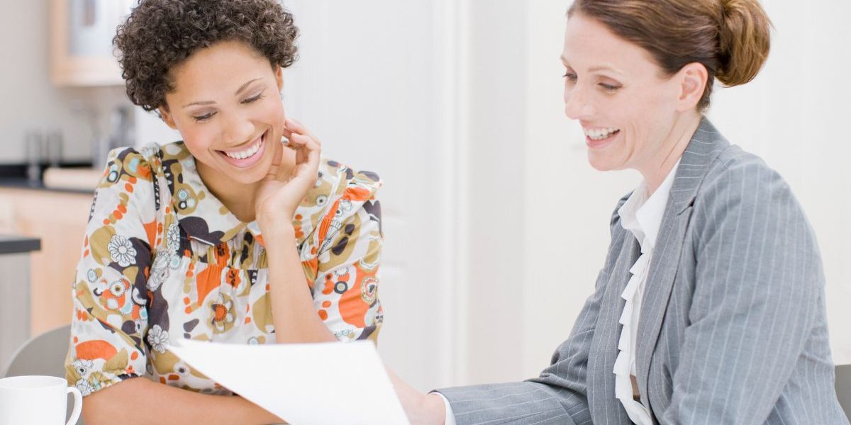 two women reviewing paper work
