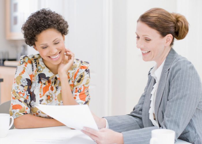two women reviewing paper work
